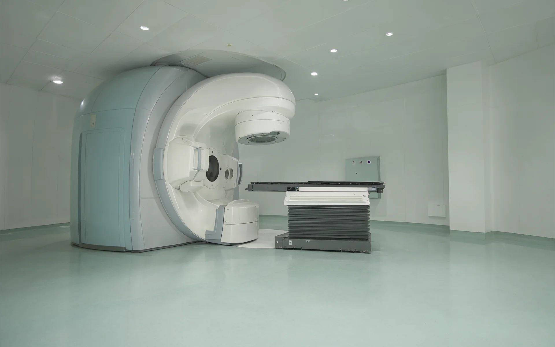 A proton therapy treatment room with a large circular gantry.